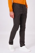 Three-quarter front view of dark brown stretch cotton trousers on a model