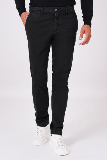 Front view of black stretch cotton trousers on a model