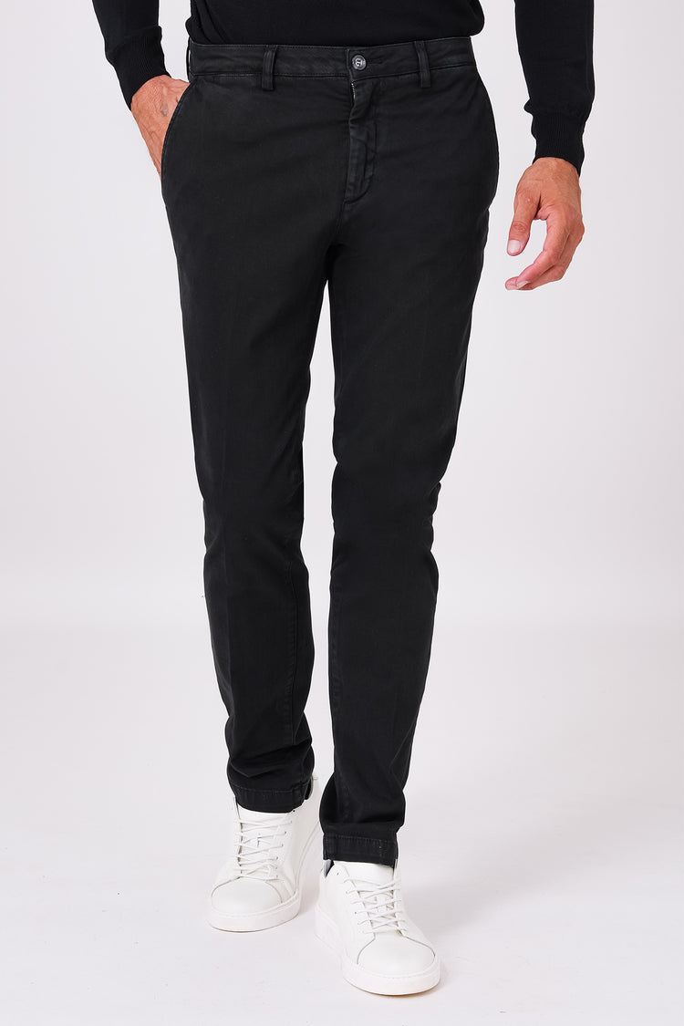 Front view of black stretch cotton trousers on a model