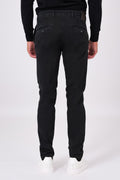 Rear view of basic black stretch cotton trousers on a model