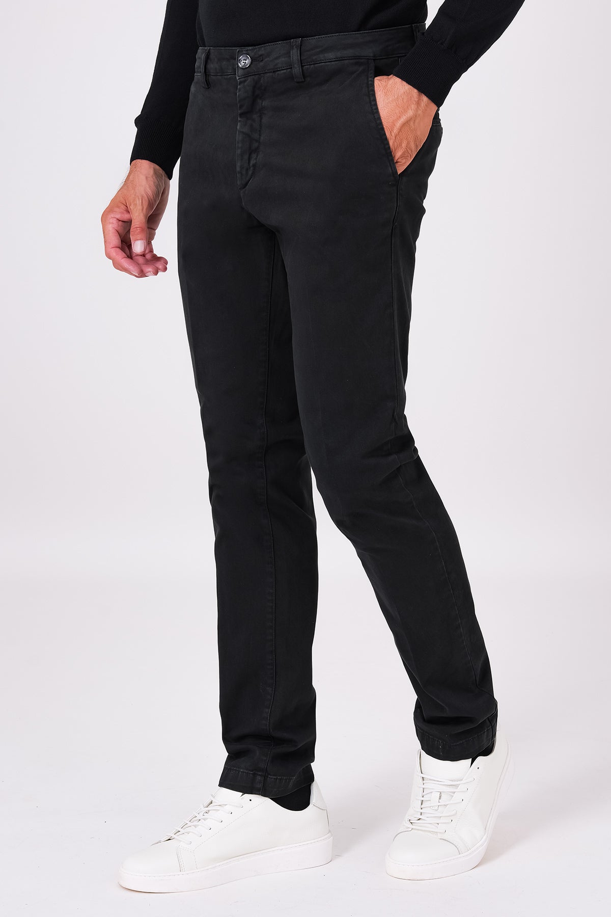 Front view of basic black stretch cotton trousers on a model