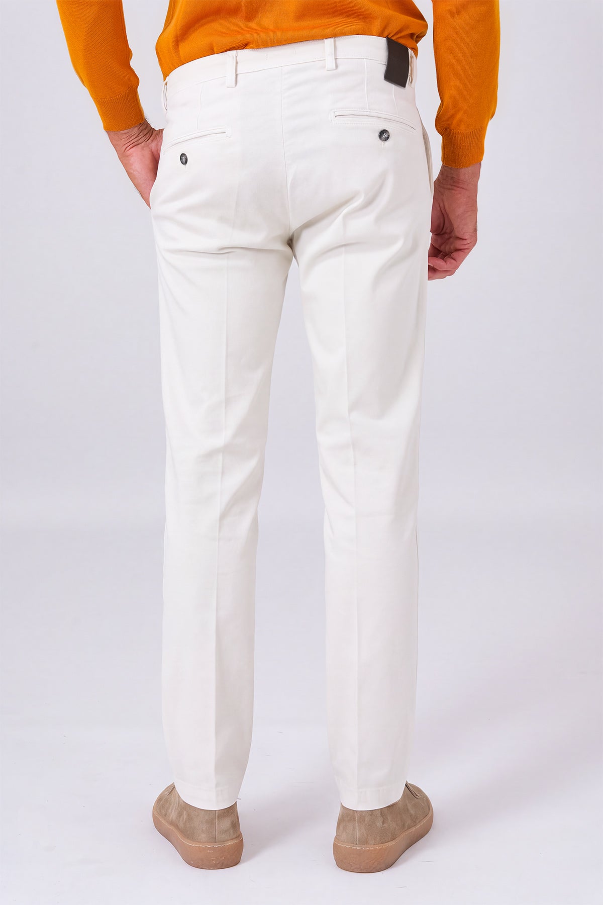 Rear view of cream stretch cotton trousers on a model