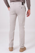Back view of sand-coloured stretch cotton trousers on a model