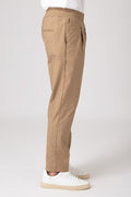 Man in profile wearing beige elastic waist carrot pants