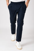 Man wearing blue carrot pants with elastic waist front view