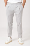 Man wearing grey elastic waist carrot pants front view