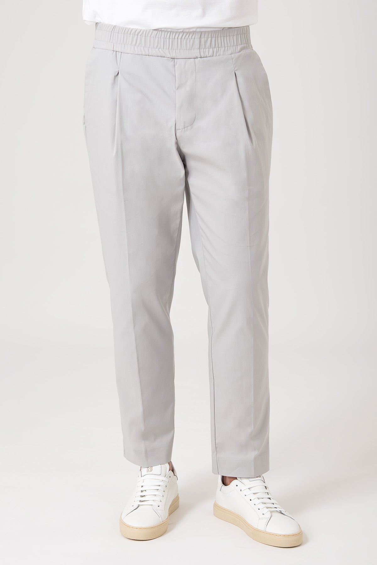 Man wearing gray carrot pants with elasticized waist front view
