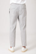 Man wearing grey carrot pants with elastic waist back view