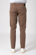 Man wearing stretch cotton pants in earth tone back view