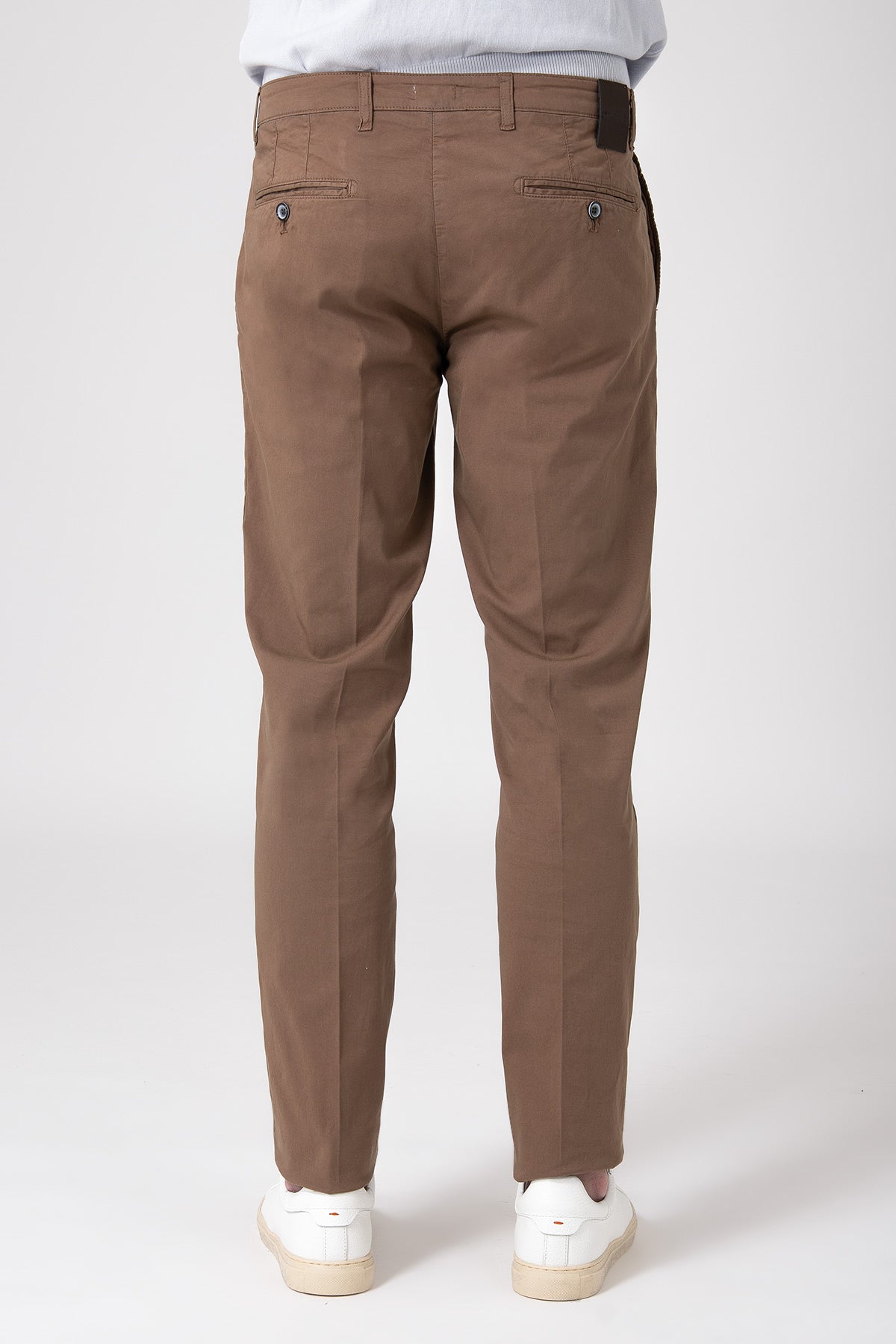 Man wearing stretch cotton pants in earth tone back view