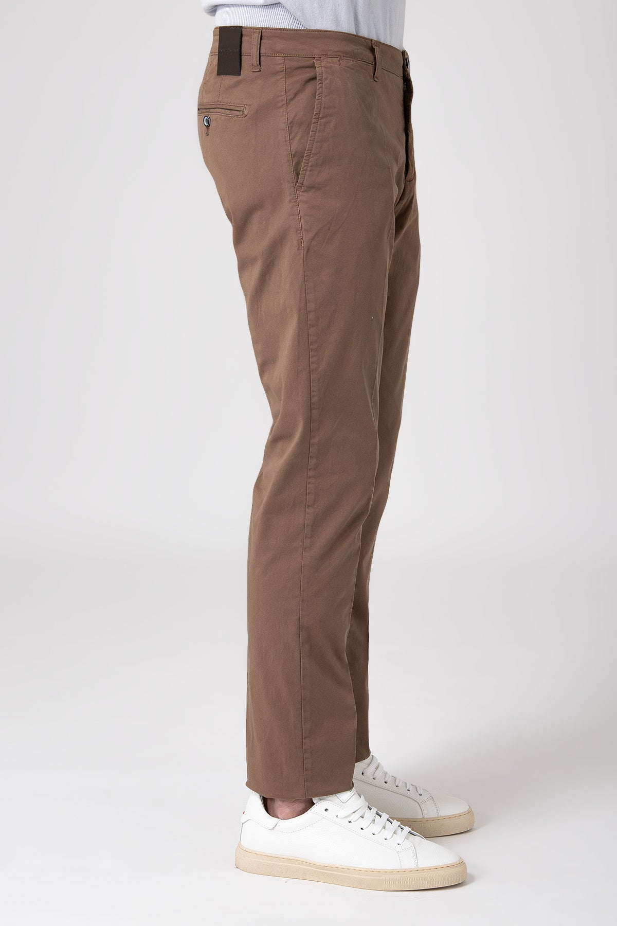 Side view of a man wearing stretch cotton pants in mud color