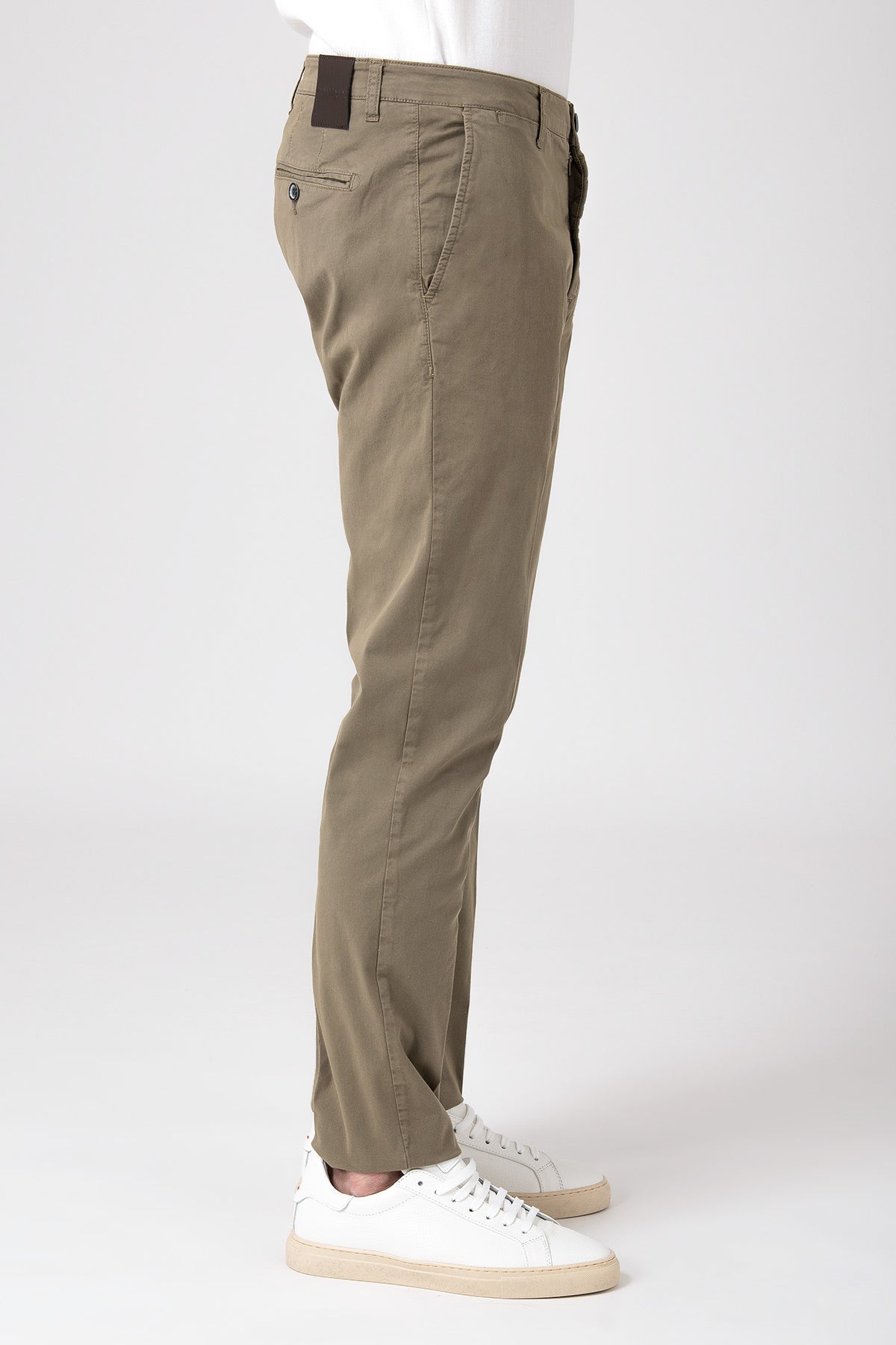 Side view of man wearing stretch cotton pants in mud color