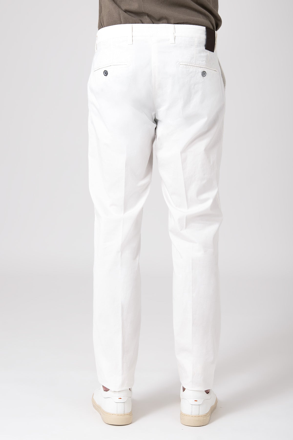 Man wearing cream stretch cotton pants rear view