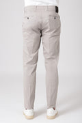Man wearing sand stretch cotton trousers seen from behind
