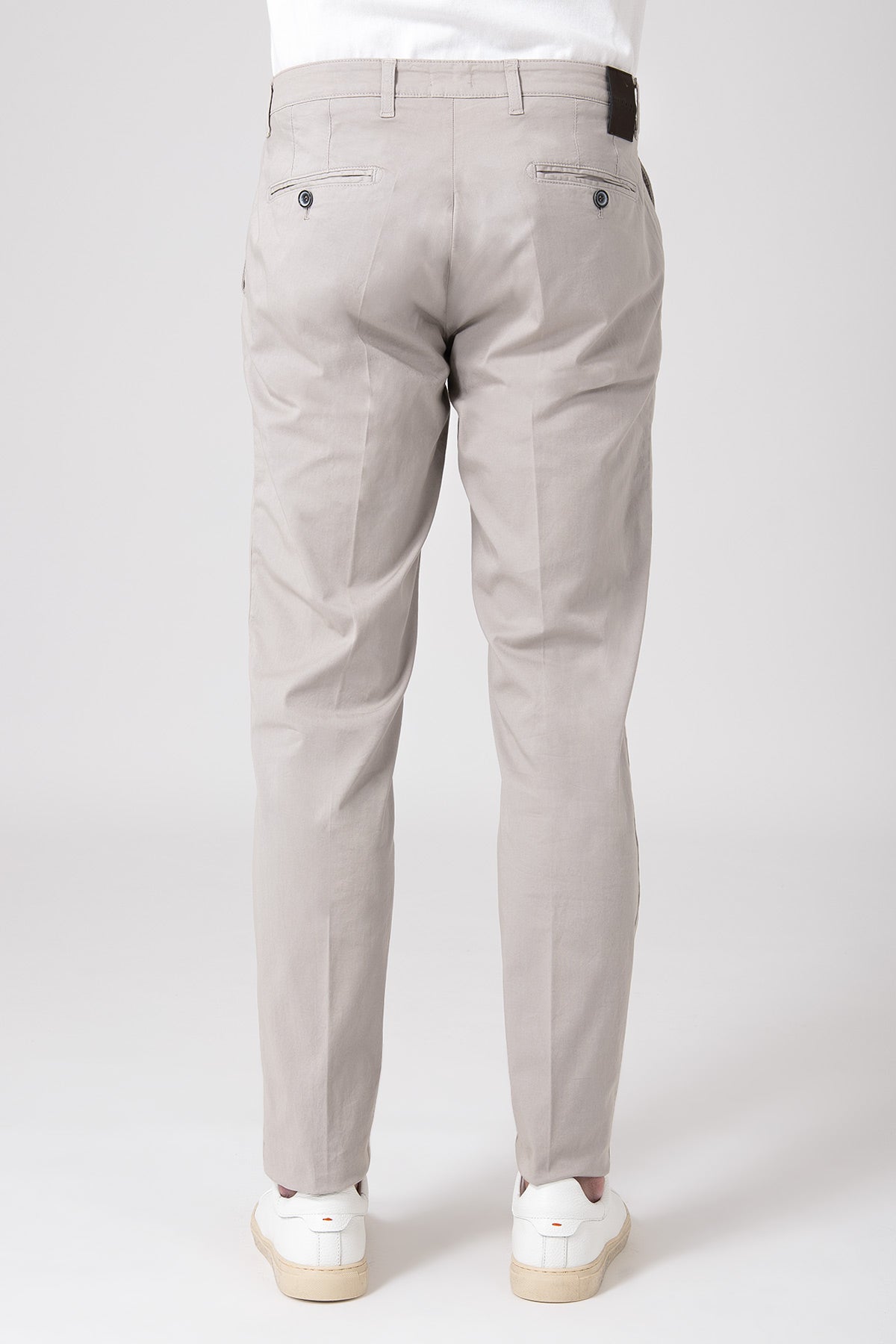 Man wearing sand stretch cotton trousers seen from behind
