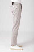 Man wearing sand stretch cotton pants with white sneakers side view