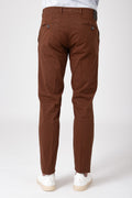 Man wearing stretch cotton trousers in mud color back view