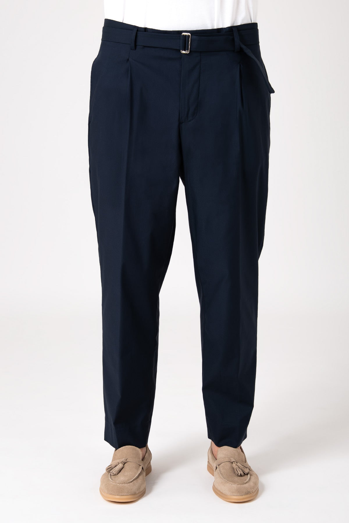 Man wearing blue pants with strap and pleats front view