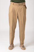 Man wearing beige trousers with strap and pleats front view