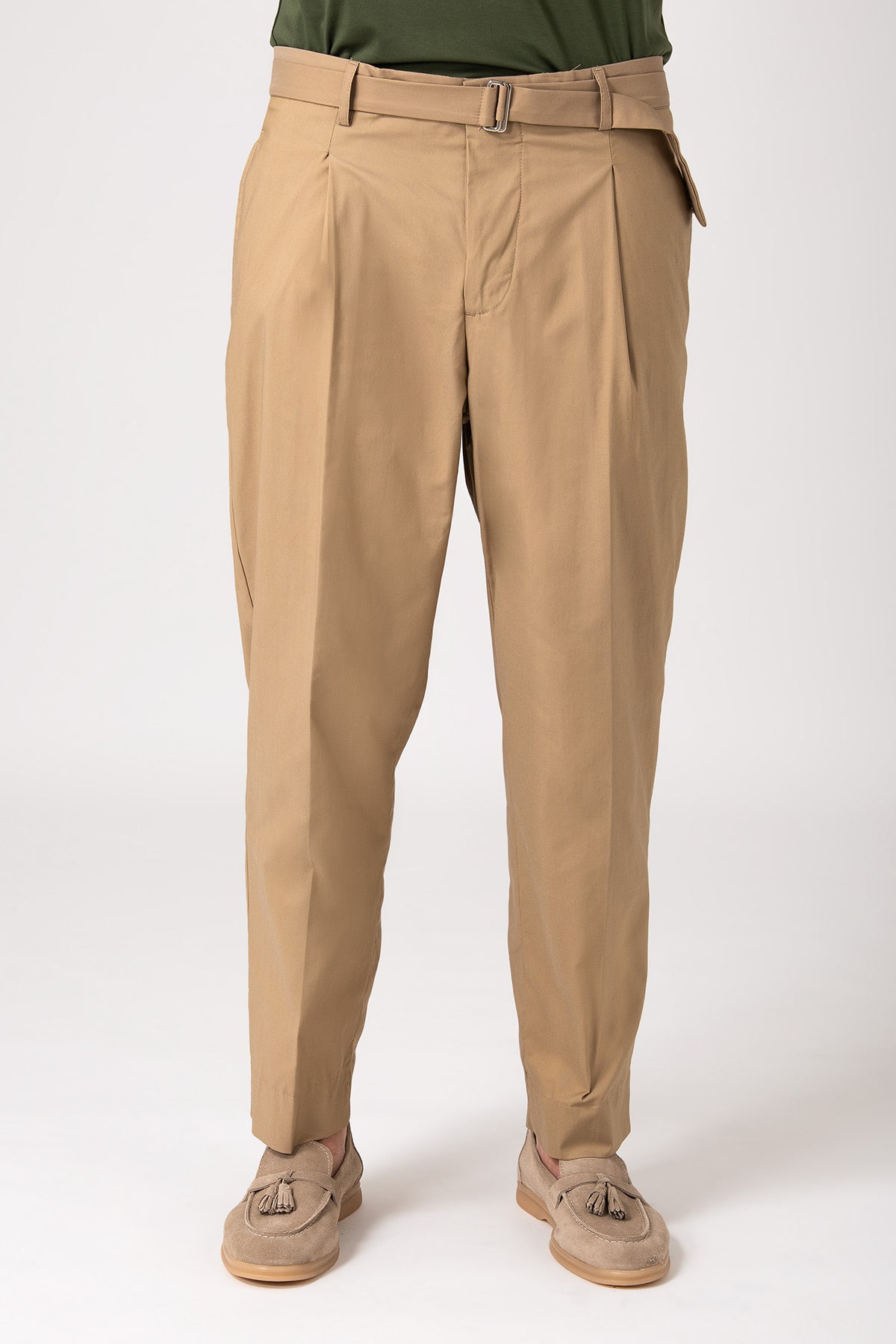 Man wearing beige trousers with strap and pleats front view
