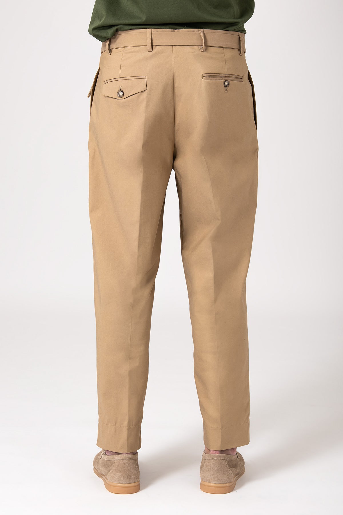 Back view of man wearing beige trousers with strap and panel detail