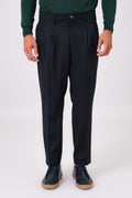 Front view of blue double-pleated trousers on a model