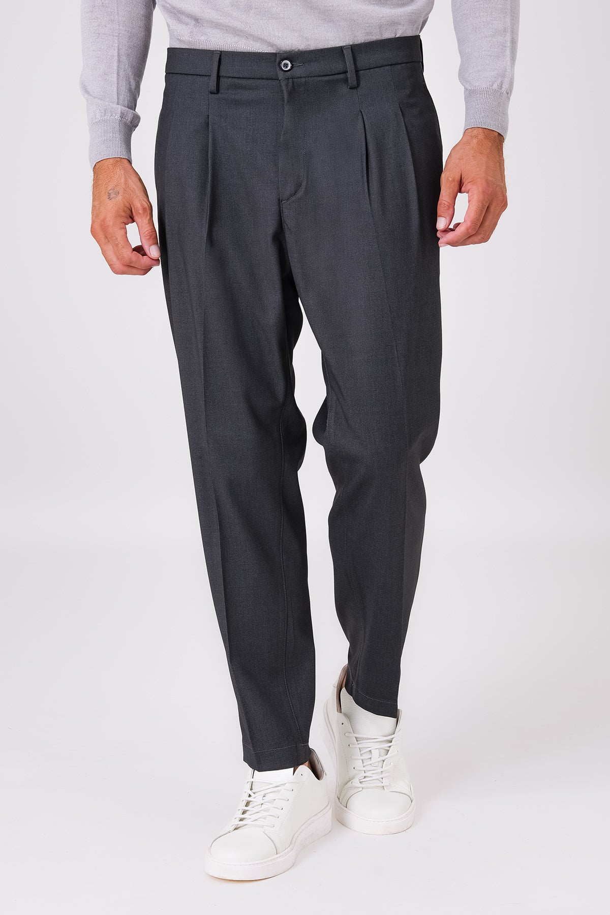Front view of smoke grey double-pleated trousers on a model