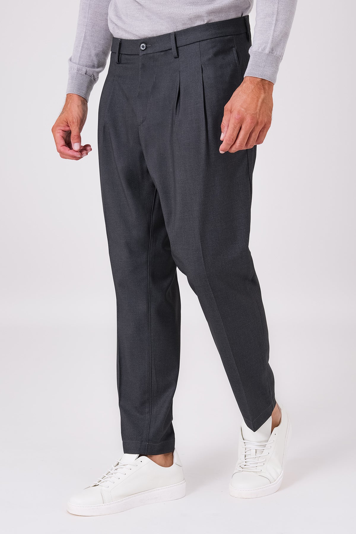 Smoke grey double-pleated trousers on a model, front view