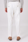 Rear view of cream trousers on a model, with welt pockets and buttons