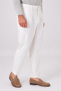 Cream double-pleated trousers on a model, front view