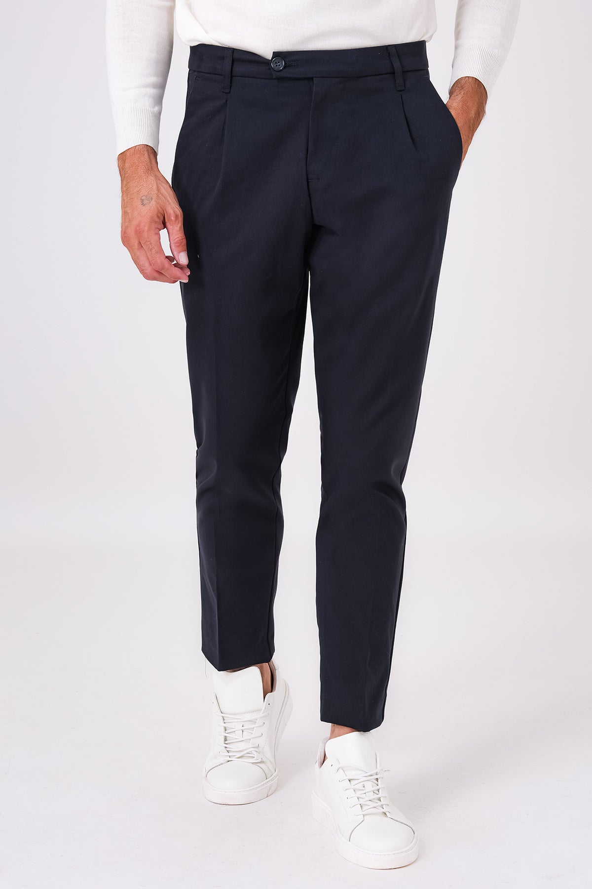 Front view of blue stretch-cotton pleated trousers on a model