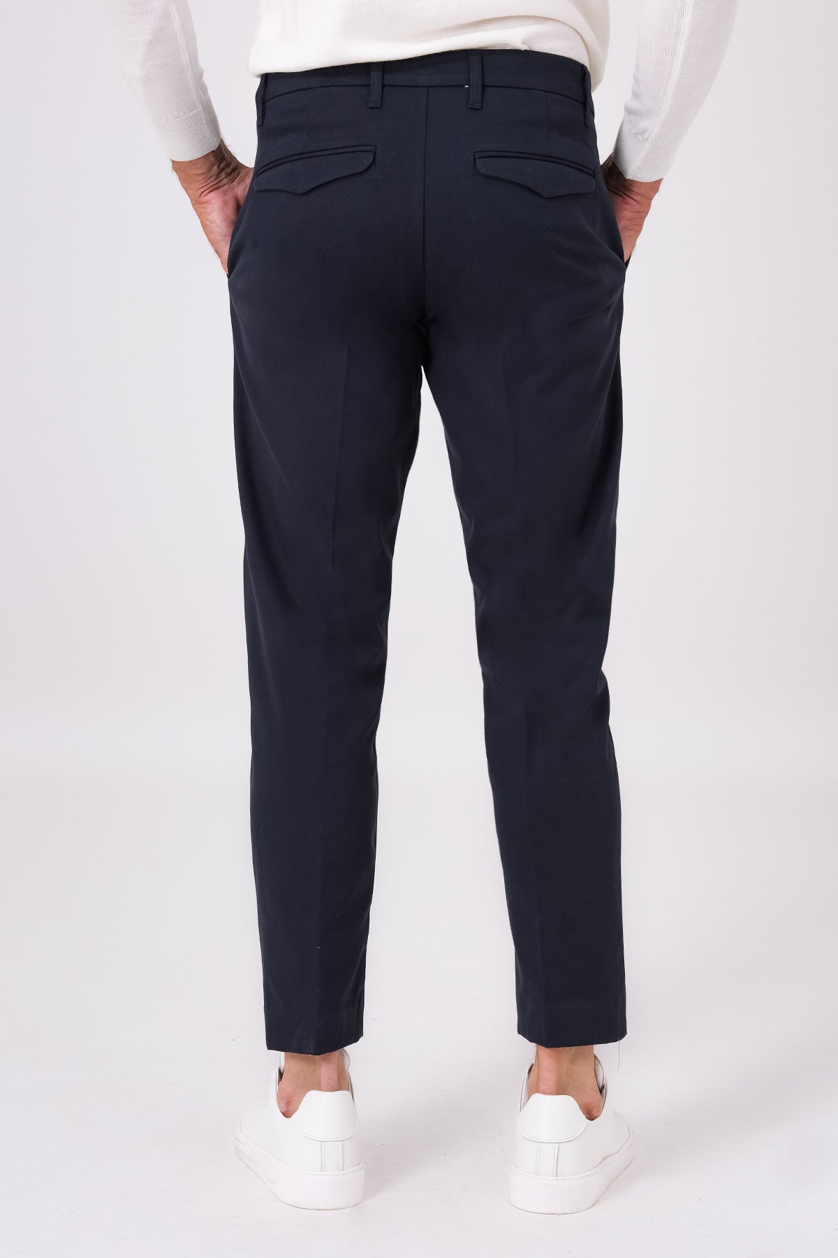 Rear view of blue stretch cotton trousers on a model