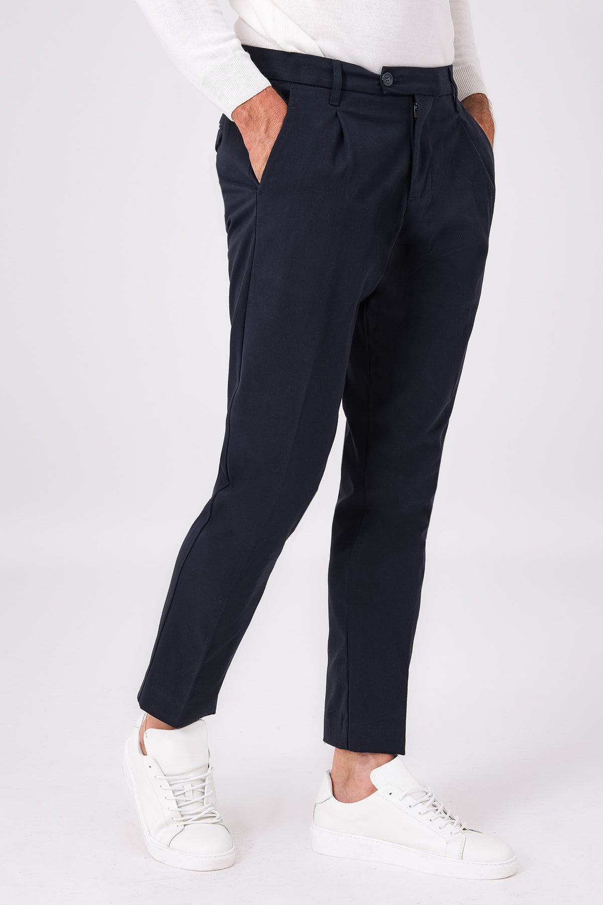 Blue pleated stretch-cotton trousers on a model, front view