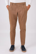 Front view of mud brown stretch cotton pleated trousers on a model