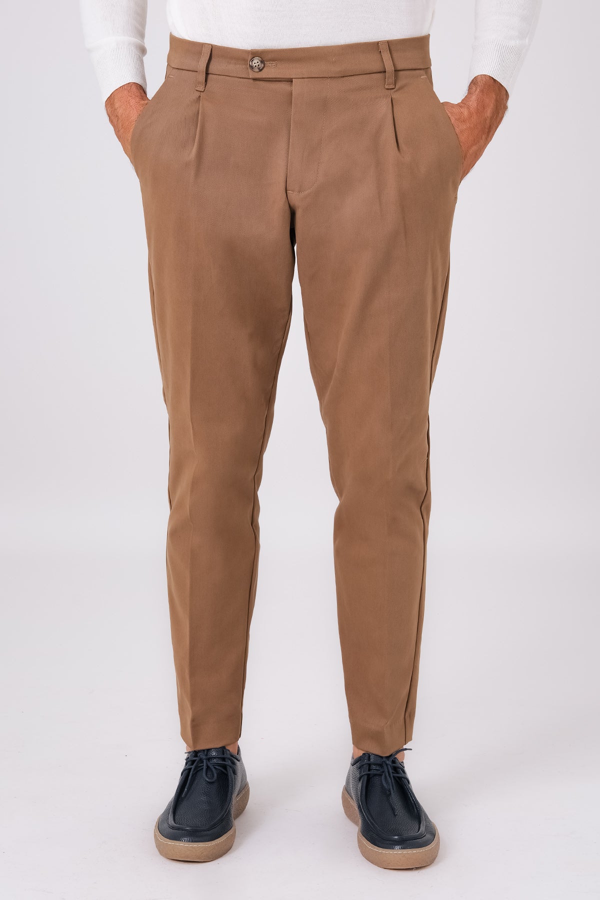 Front view of mud brown stretch cotton pleated trousers on a model