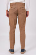 Back view of mud brown stretch cotton trousers on a model