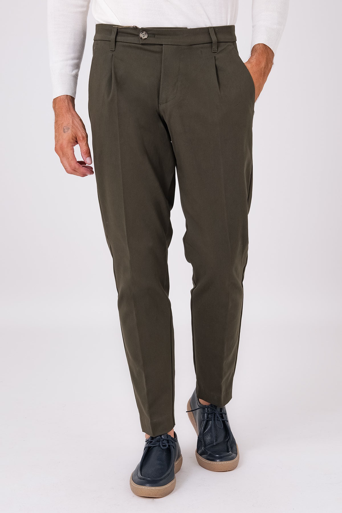 Front view of military green stretch cotton pleated trousers on a model