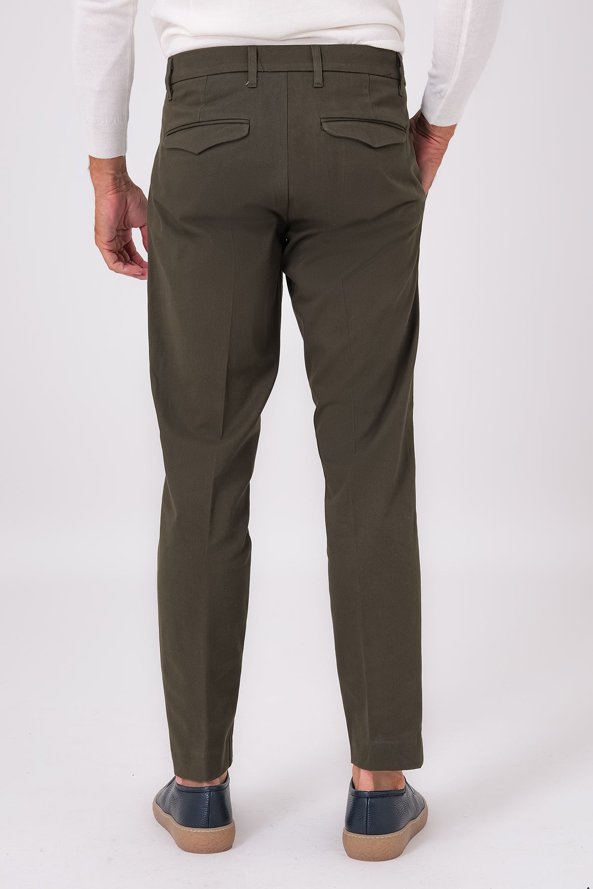 Rear view of military green pleated trousers on a model