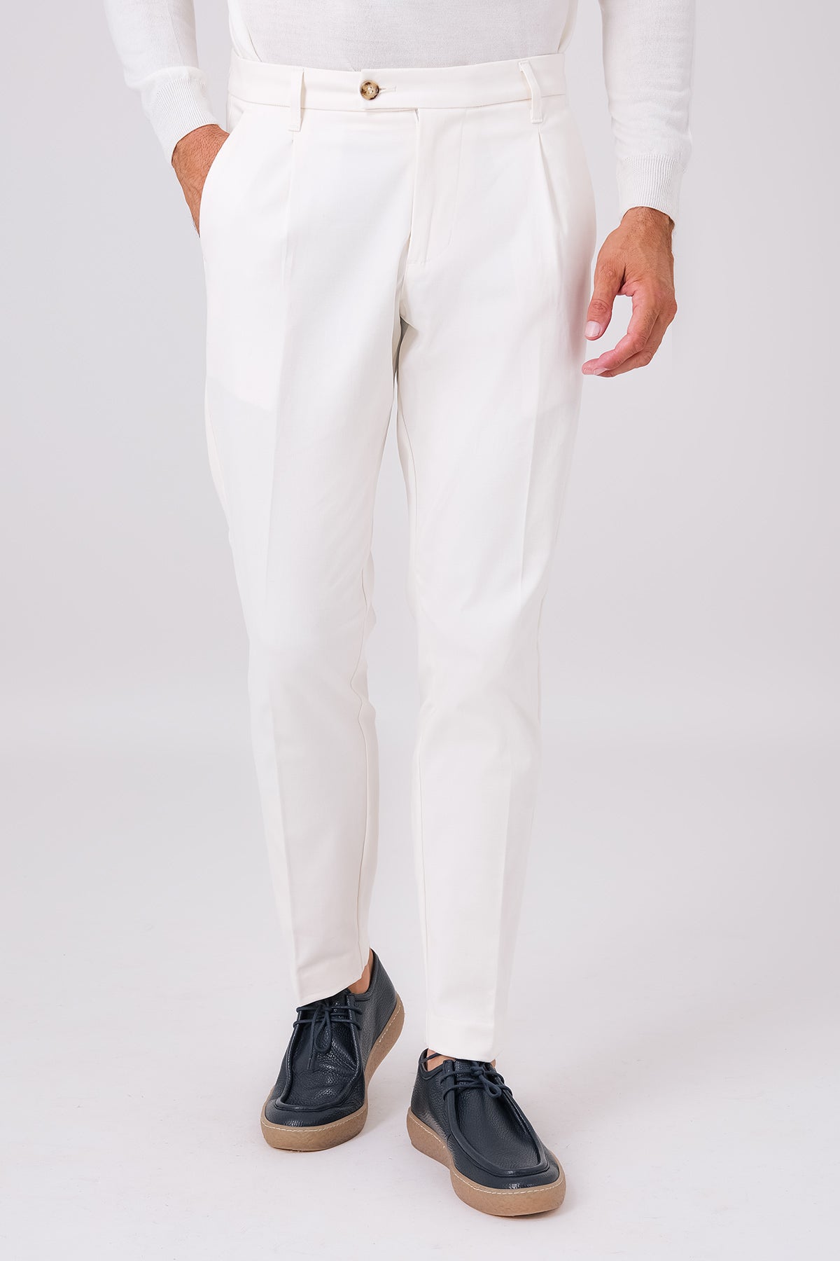 Cream stretch cotton pleated trousers on a model, front view