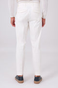 Rear view of cream pleated trousers on a model