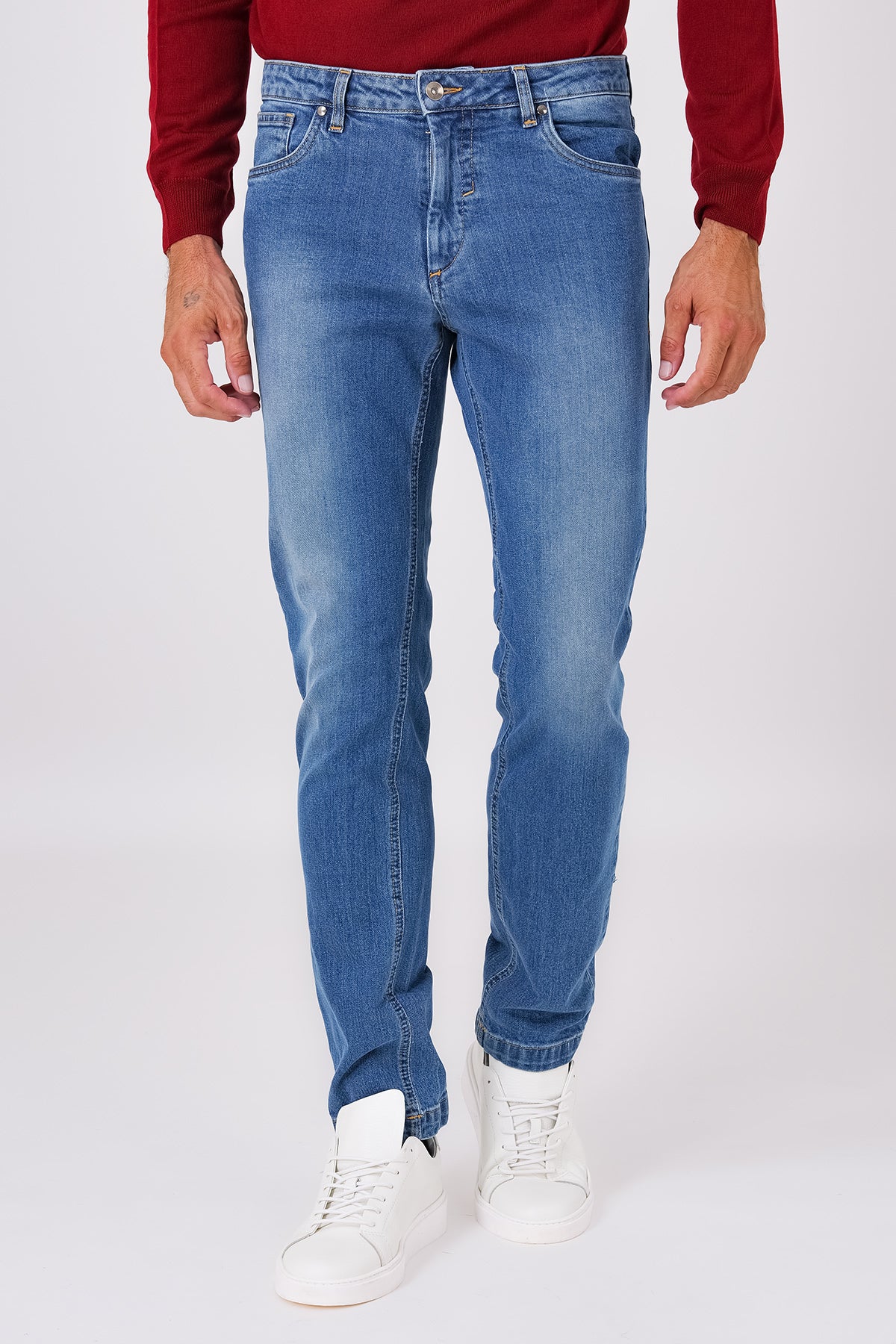 Front view of denim-blue five-pocket denim trousers on a model