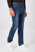 Three-quarter front view of medium denim trousers with slant pockets on a model