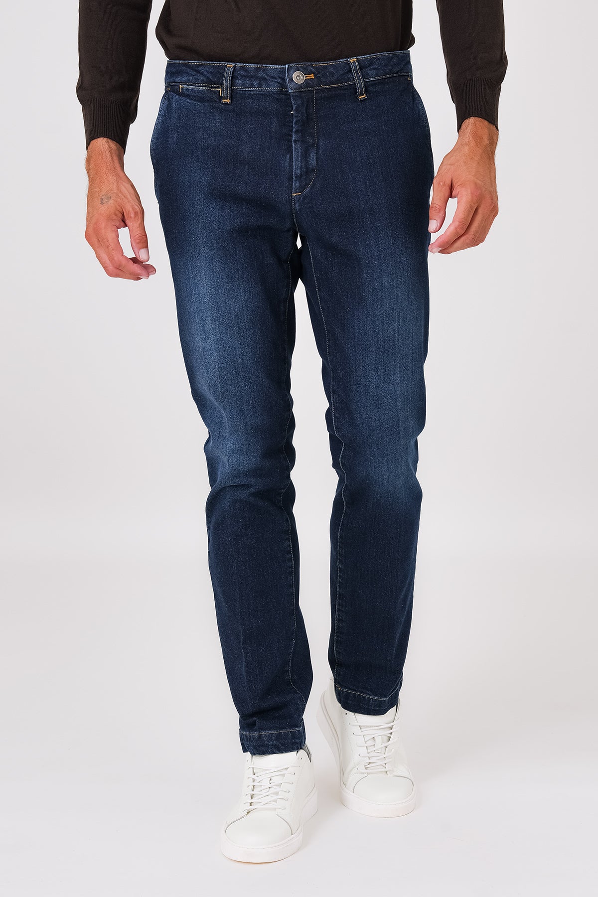 Dark denim trousers with slant pockets on a model, front view