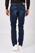 Rear view of dark denim trousers on a model, with buttoned welt pockets