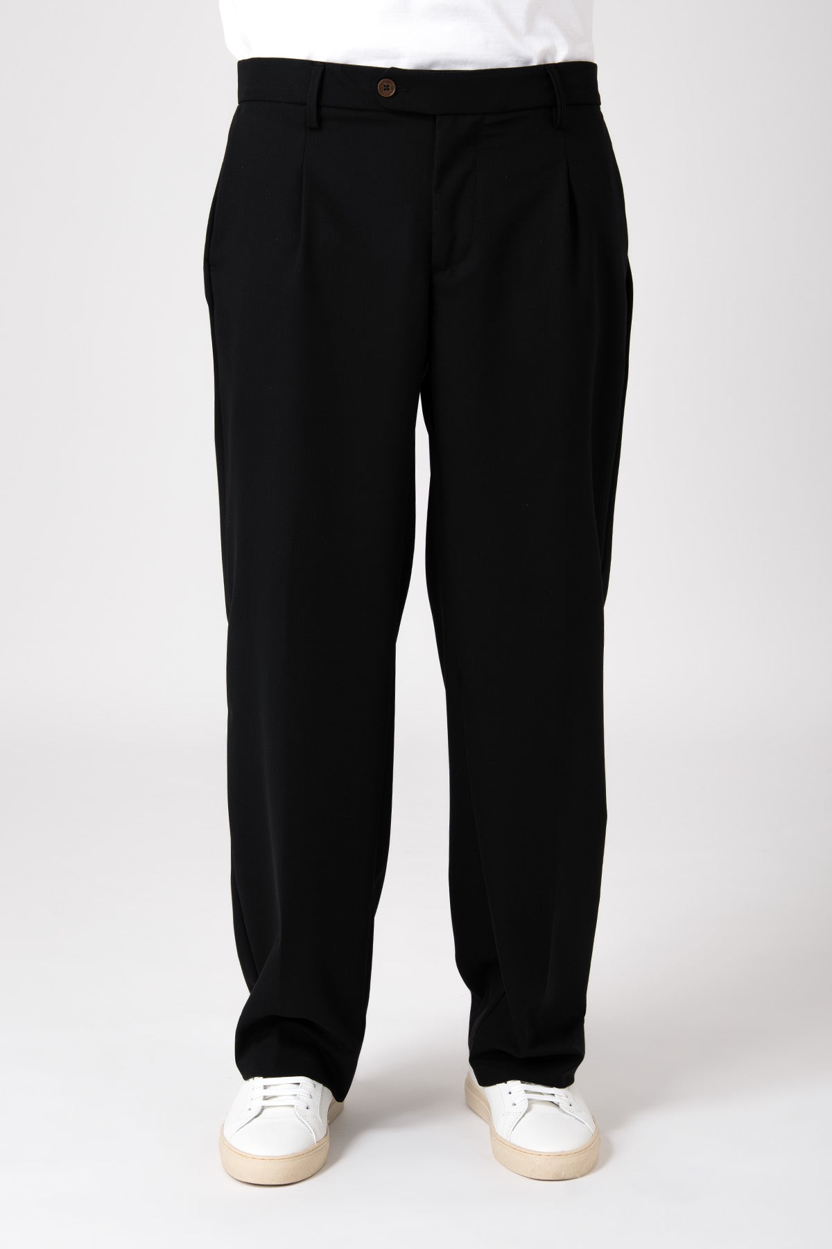Uomo che indossa un pantalone largo nero fluido con vista frontale