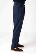 Man wearing blue wool French pence trousers with elastic waist side profile