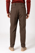 Man wearing brown wool French pence trousers seen from behind