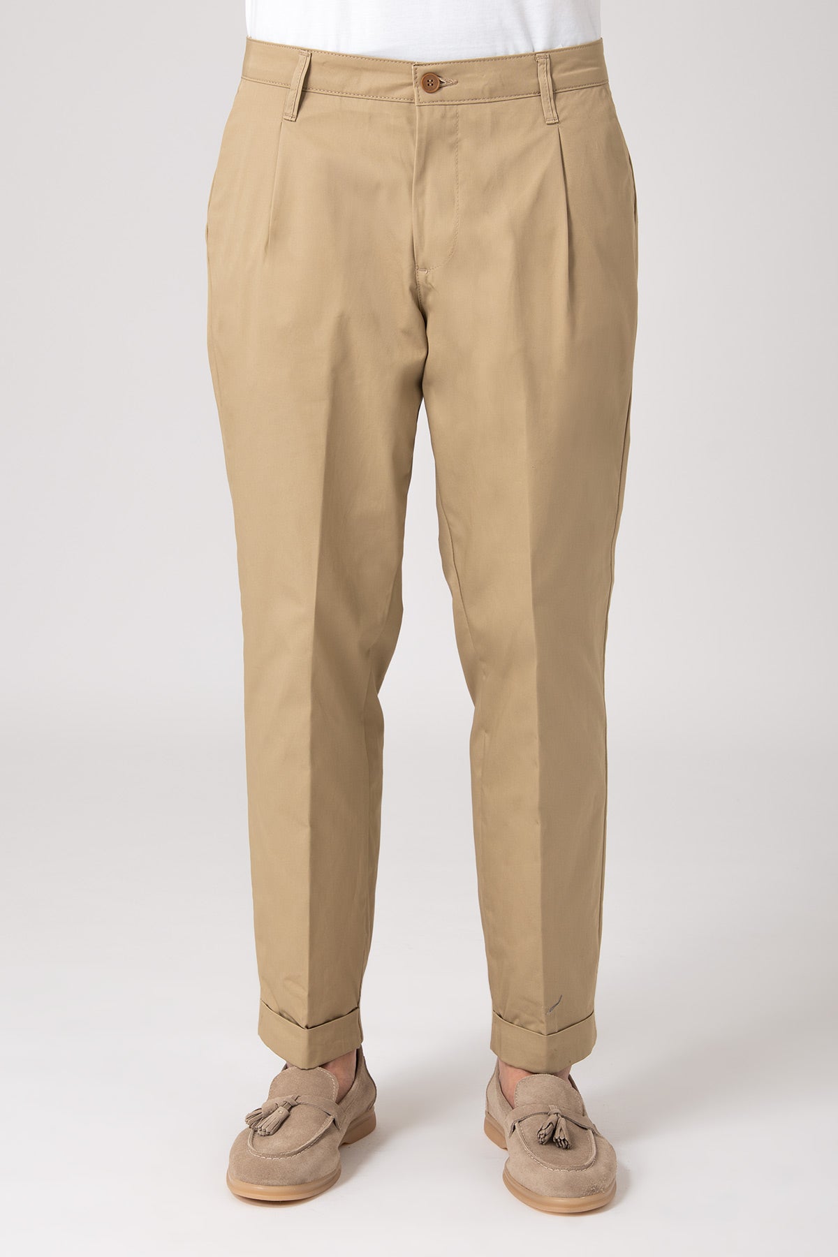 Man wearing high-waisted beige pants with darts front view
