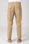 Man wearing beige high-waisted trousers with darts back view