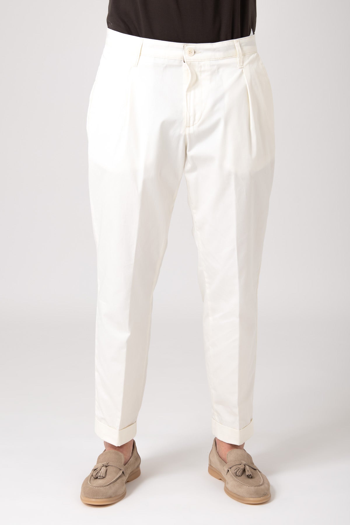 Front view of man wearing white high-waisted trousers with darts